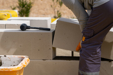 The bricklayer is working. Building a wall of aerated concrete. Gasbeton wall
