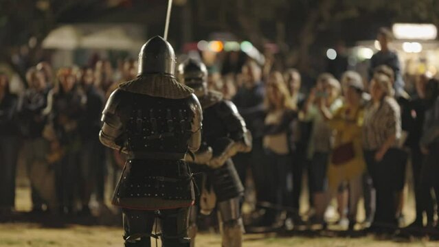 Show of medieval gladiatorial fights on the street surrounded by people