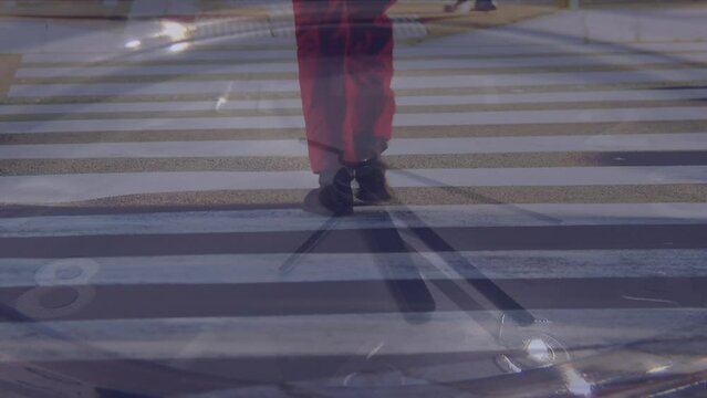 Animation of moving hands on clock over feet walking on pedestrian crossing at night