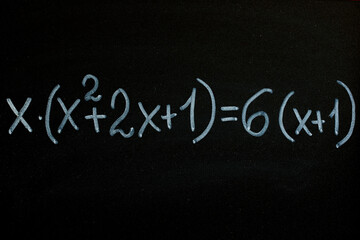 Quadratic equation draw by white chalk on blackboard background