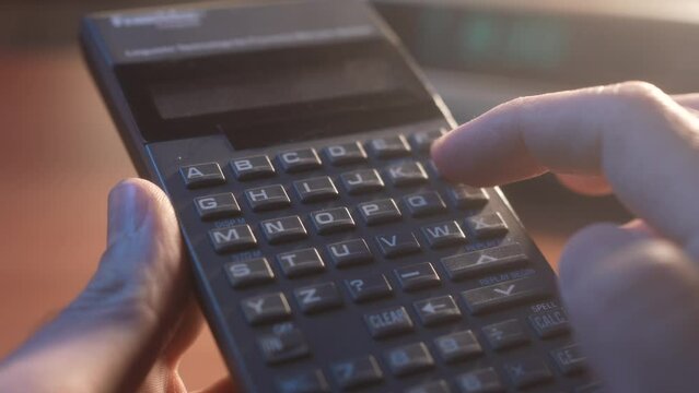Typing Text on a Retro Keyboard Device from the 80s 90s Closeup