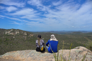 Fototapeta premium couple on the mountain, hiker in the mountains, love between friends, hikers, couple on the trail, couple looking at the horizon, couple looking at landscape, mountaineering
