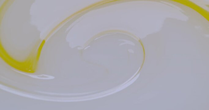 Slow motion The begin of a combination of white and yellow liquid cream.