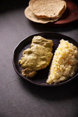 Pipian, also known as Mole Verde, food from Mexico and other Latin American countries, chicken meat bathed in mole sauce made with pumpkin seeds, dried chili peppers and several other ingredients.