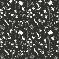 Monochrome eamless pattern with black wild flowers silhouettes on white background. Vintage ditsy floral repeat pattern.