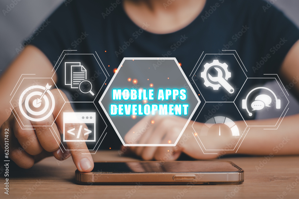 Poster mobile apps development concept, person hand touching on smart phone on desk with mobile apps develo
