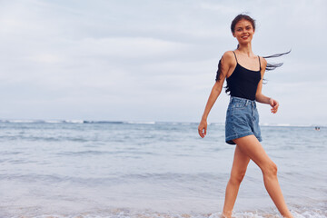 Fototapeta na wymiar woman sea travel running beach sunset young smile lifestyle summer relax