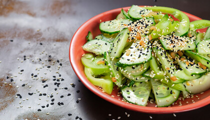 Salad of cucumber, sesame seeds and pepper.