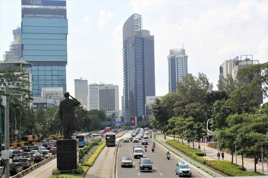 Jakarta, Indonesia-18 June 2023 : view of sudirman street with sudirman statue in the middle