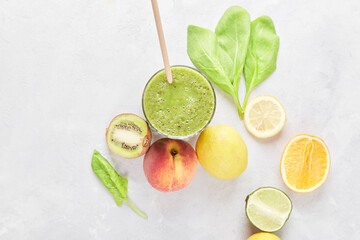 Healthy fresh smoothie drink with kiwi, peach, orange and spinach on the table flat lay. Vegan,...