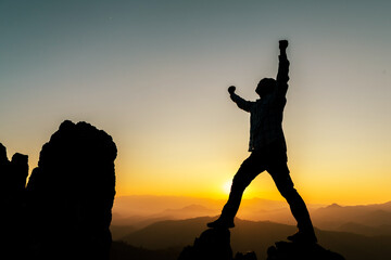 Men traveling as a backpacker enjoying the natural scenery, happiness, traveling on the top of the mountain. Watch the sunset with a large backpack. travel lifestyle summer adventure Outdoor