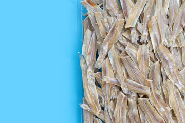 Dried anchovy on blue background.