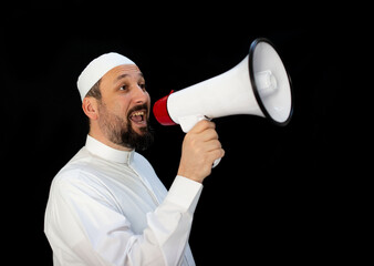 Handsome man with beard shouting through megaphone for Hajj in Mekkah