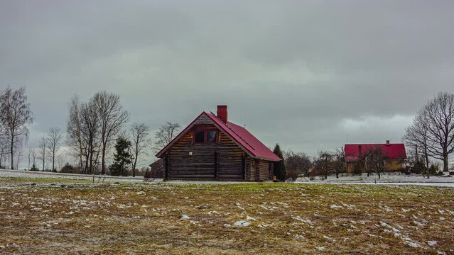 A time lapse of a  wood cabin with storm clouds flying overhead.