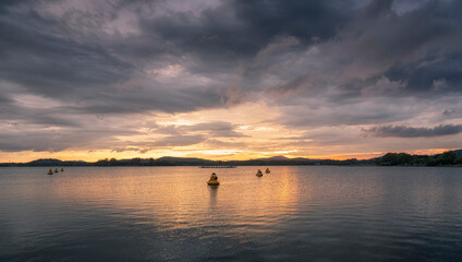 Fototapeta na wymiar Some decorative ducks in the lake at sunset