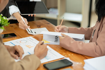 Asian business presents to explain the graph work on the whiteboard. Consulting, discussing, exchanging knowledge.