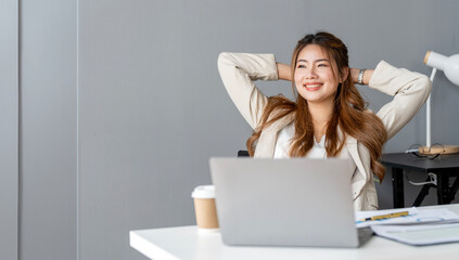 Portrait of a relaxed young businesswoman sitting at office.