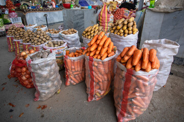 The carrots and potatoes in the bazaar.
