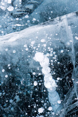 Naklejka na ściany i meble Gas methane bubbles frozen in blue ice of lake Baikal