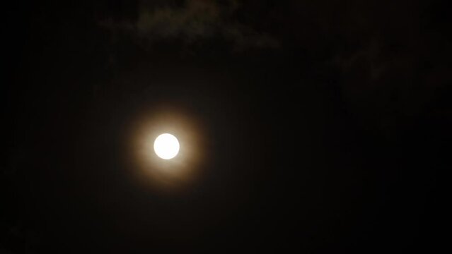 Full moon time-lapse photography in cloudy weather at night, dark and windy night