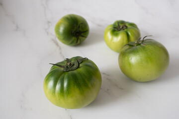 Green Salty Tomatoes on white background