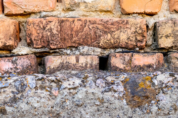 Part of a brick wall on a concrete foundation