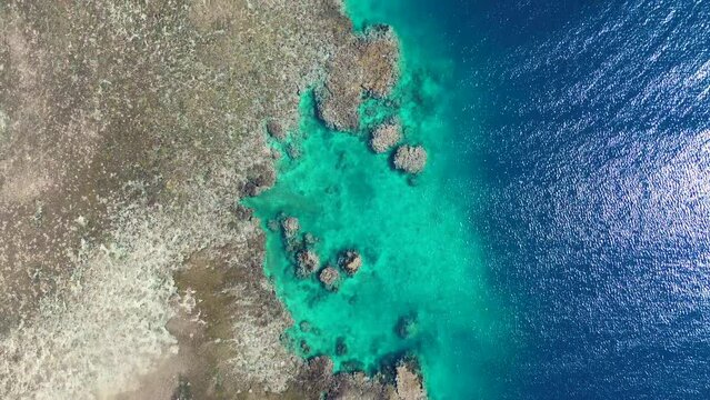 Aerial drone shot of crystal clear rocky coastline snorkel diving spot coral reef inlet water ocean holiday trip Hideaway Mele Island Port Vila Vanuatu 4K