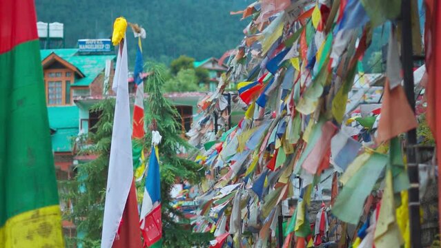 Close up shot of colorful Buddhist prayer flags in Buddhist monastery in Himachal Pradesh, India. Tibetan Buddhism prayer flags  with Buddhist mantra prayer written on it