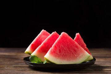 Fresh sliced watermelon on wooden background
