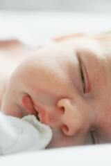 Newborn face closeup, natural colours