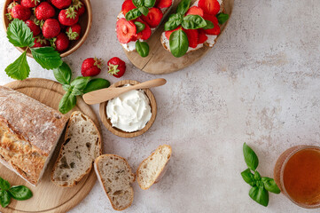 sandwich of homemade bread, cream cheese, strawberries and basil