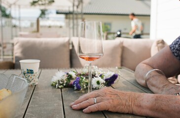 lady holding a wine glass next to a midsummer flower crown