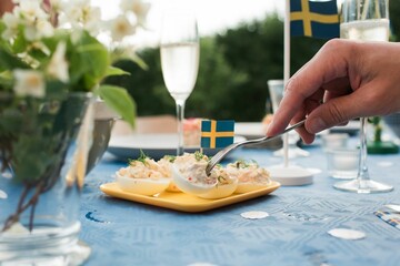 person serving traditional Swedish food at a party