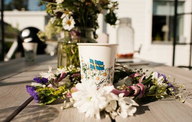 paper cup on an outdoor table at a midsummer party in Sweden