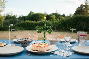 Midsummer outdoor table with traditional Swedish food