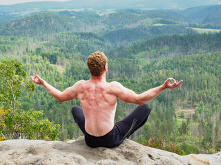 Shirtless man relaxing meditation with view mountains