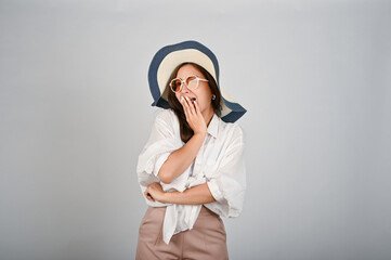 Portrait of young charming and cheerful Asian woman wearing hat. Holiday and travel concept