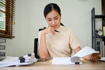 Young overwork stressful female working at her desk