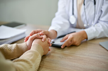 Close up view of doctor touching patient hand, showing empty and kindness. - obrazy, fototapety, plakaty