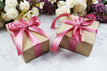 Gift boxes and flower bouquet with space copy on marble background