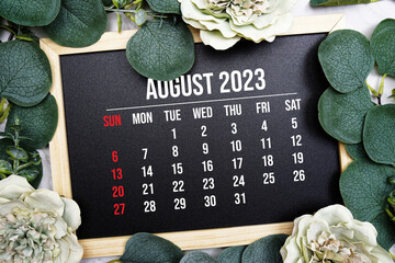 August 2023 monthly calendar with flower bouquet decoration on marble background