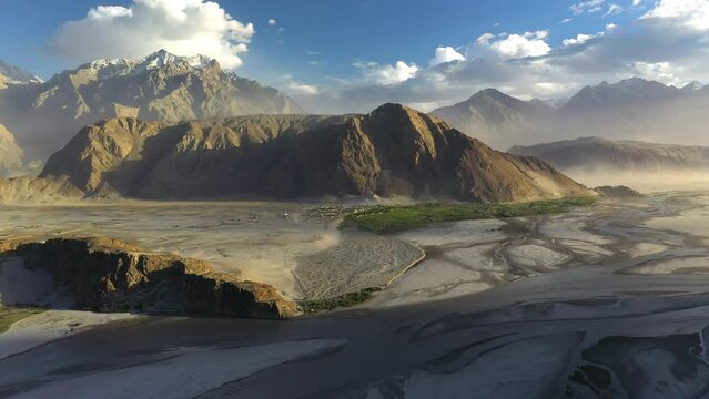 Cinematic aerial shot of Skardu Valley in Gilgit Baltistan, Pakistan. Wide slowing revealing and over water in the valley. Shigar and Indus River. Epic drone shot.