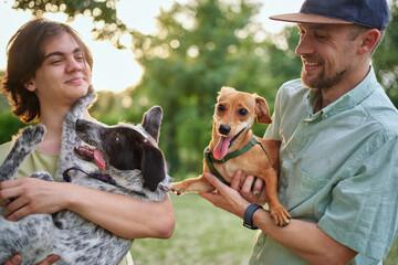Support, care or happy family, men and kids bonding with foster puppy or pet and enjoying time together. High quality photo