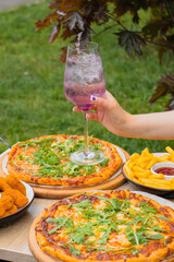 Two pan pizzas in two pizza boxes with their two different flavors