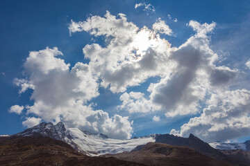 Summer panorama of Barba d'Orso Glacier sorrounded by snow capped peaks. The glacier is in rapid retreat caused by global warming, Alto Adige, Italy. Popular mountain with climbers