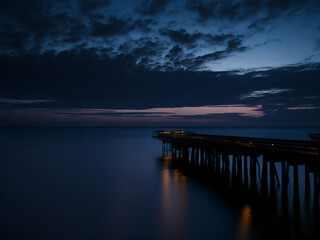 Beautiful seascape with pier at sunset. Long exposure.