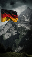 Germany Flag in the Wind Over Majestic Mountains