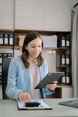 Businesswoman using calculator and laptop for calculation finance, tax, accounting, statistics and analytic research concept. in the office.