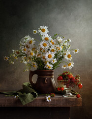 Rustic still life with a bouquet of daisies in a jug and strawberries on a dark background © 02irina