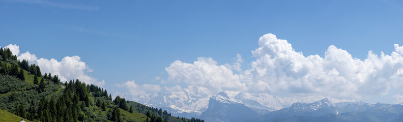 Aerial wide panorama showing Mont Blanc Massive eternal snow tops in atmospheric haze with dramatic...
